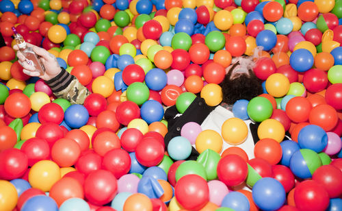 Young man playing in a ball pit