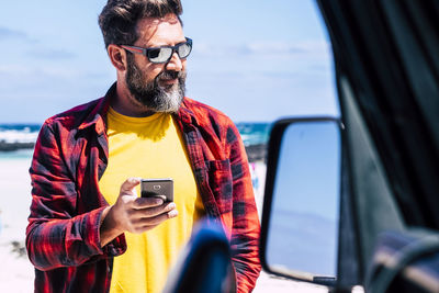 Man using mobile phone in bus