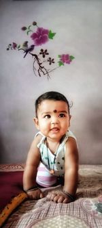 Portrait of smiling girl on bed at home