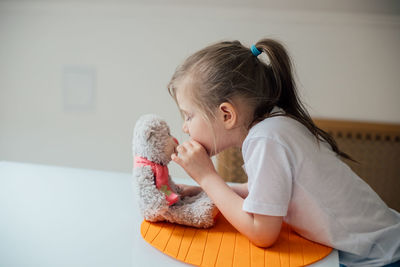 Cute girl with toy at home