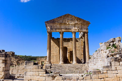 Old ruins of temple against clear blue sky