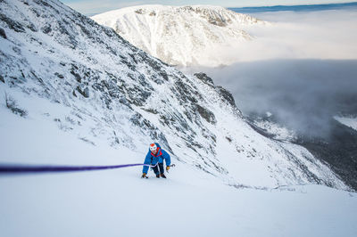 People skiing on snowcapped mountains during winter