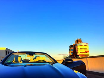 Yellow car on road against blue sky