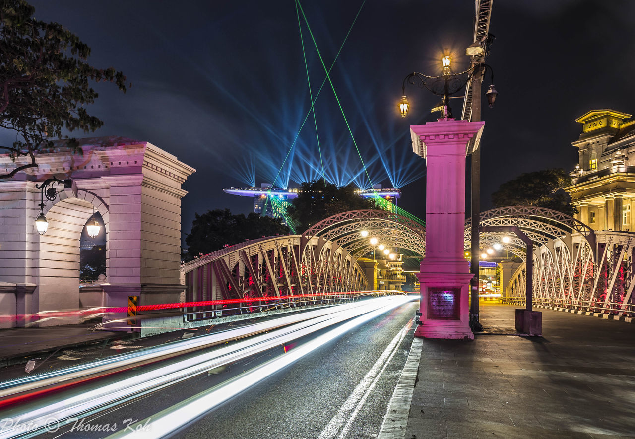 LIGHT TRAILS ON BRIDGE AT NIGHT