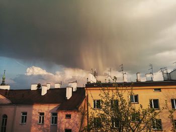 Houses against dramatic sky