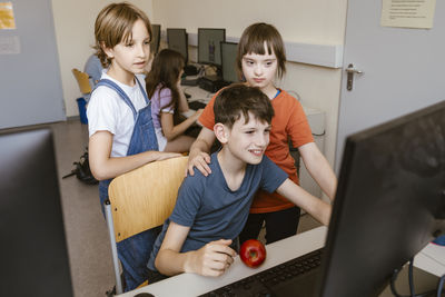 Portrait of siblings playing on table