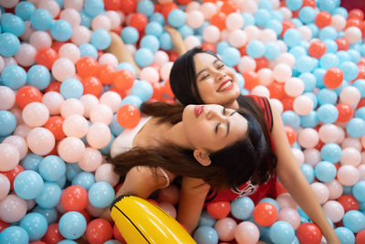 Portrait of smiling woman with colorful balloons