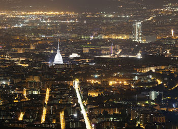 Aerial view of illuminated buildings in city at night