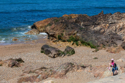 People on rocks at beach