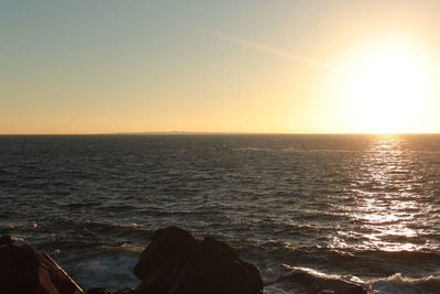 Scenic view of sea against clear sky during sunset