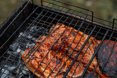 Close-up of meat on barbecue grill