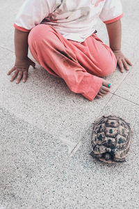 Low section of woman sitting outdoors