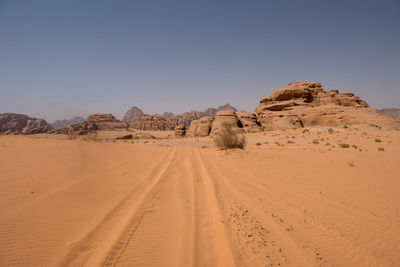 Sand dunes and sandstone cliffs in wadi rum desert , jordan