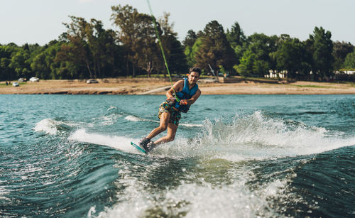 Full length of man doing wakeboard in a lake