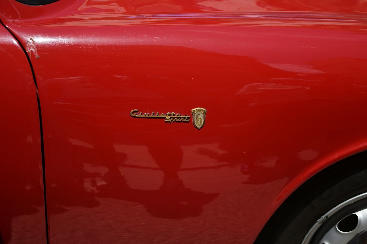 CLOSE-UP OF RED CAR ON TRUCK