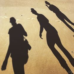 Shadow of women walking at beach