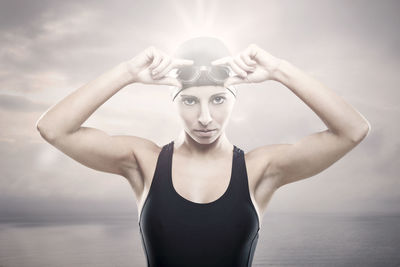 Portrait of woman standing in sea against sky