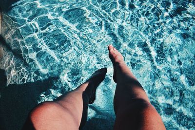 Low section of woman's  legs in water