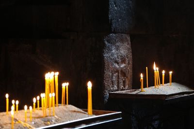 Lit candles on altars in church