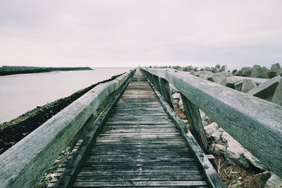 View of jetty leading to sea