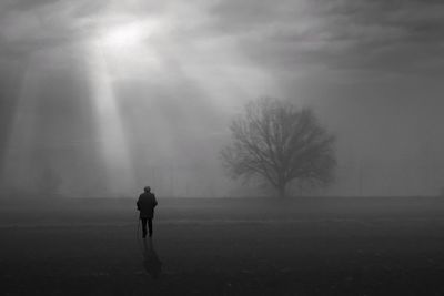 Rear view of man standing on field