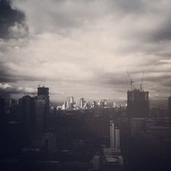 Cityscape against cloudy sky