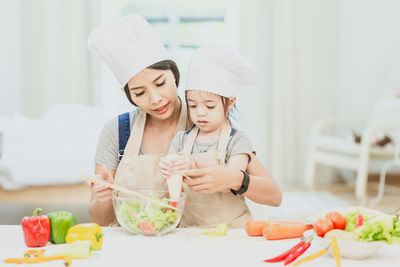 Portrait of woman with ice cream in kitchen