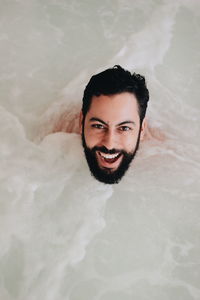Portrait of a smiling young man in water