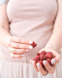 Midsection of woman holding fruit