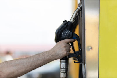 Cropped hand of man holding equipment