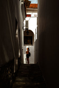 Rear view of man walking in tunnel