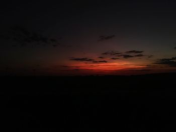 Silhouette landscape against sky at sunset