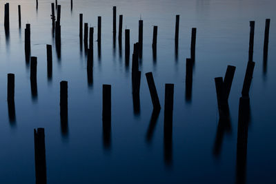 High angle view of wooden posts sea