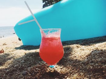 Close-up of drink on beach