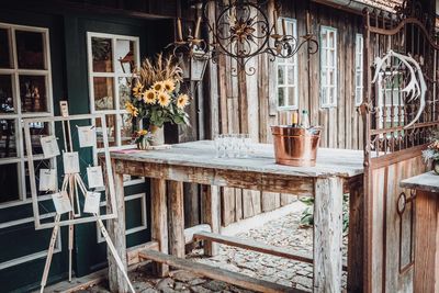 Potted plants on table by window of building