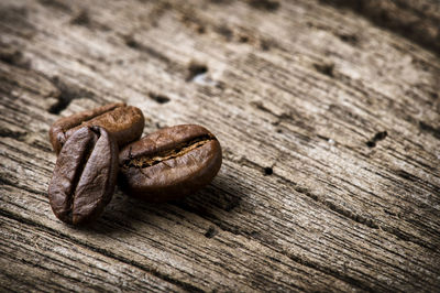 Close-up of roasted coffee beans on table