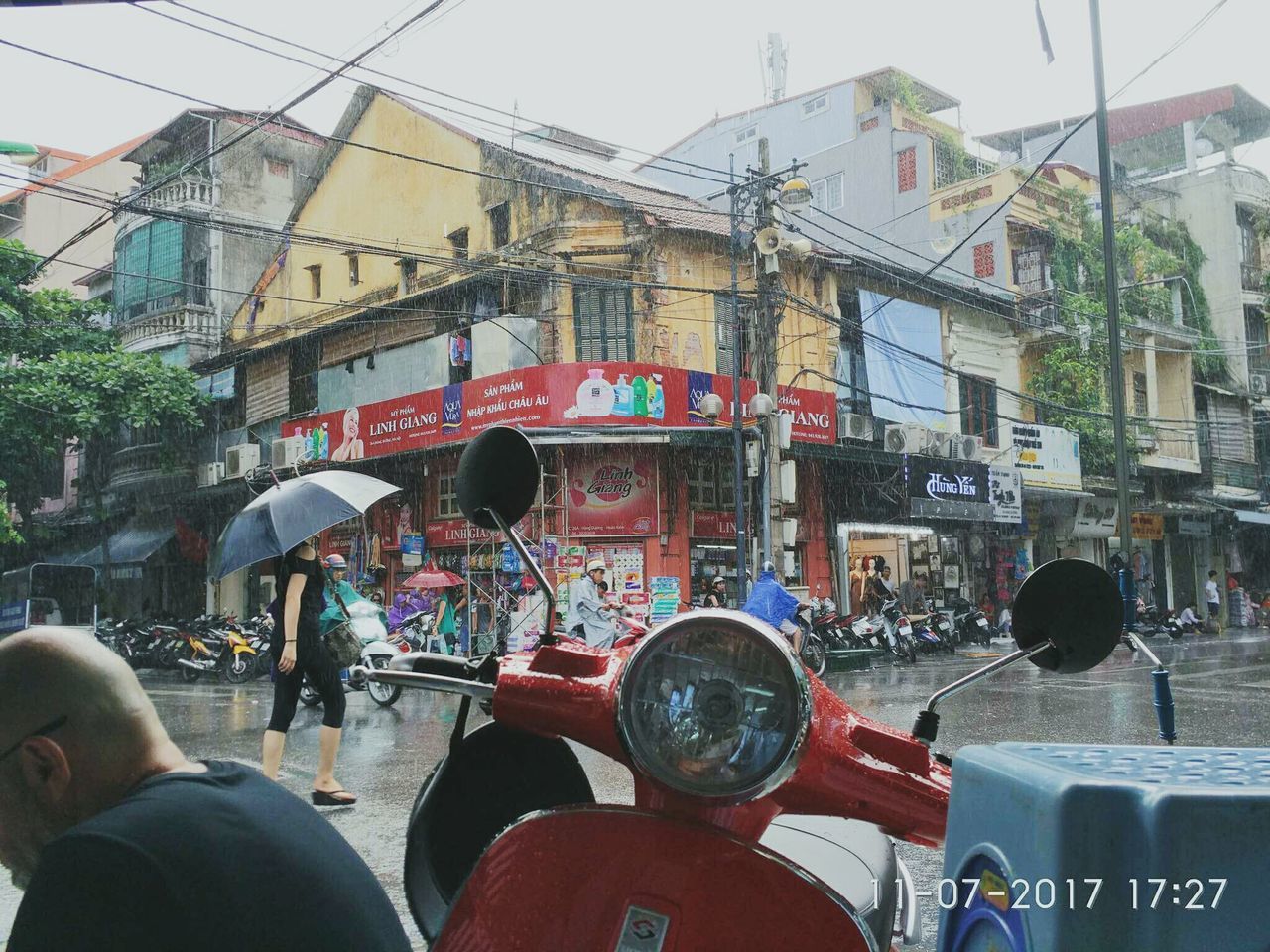 PEOPLE ON STREET AGAINST SKY