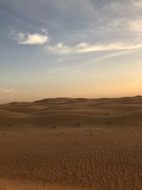 Scenic view of desert against sky during sunset