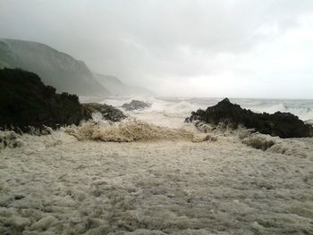 Scenic view of sea against cloudy sky