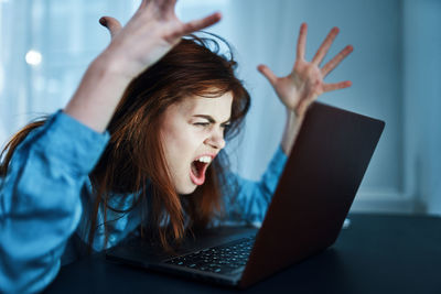 Young woman using laptop at home