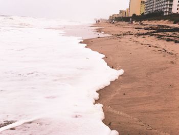 Sand on beach against sky