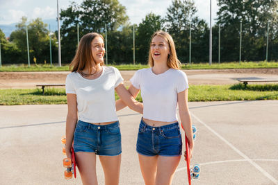 Two teenage girls having fun and holding hands