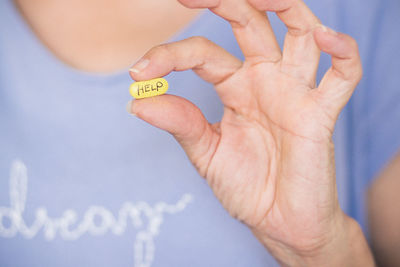 Cropped hand of woman holding thermometer