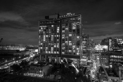 High angle view of illuminated buildings against sky at night