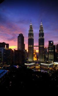 Illuminated buildings in city at dusk