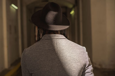 Rear view of man standing in hat
