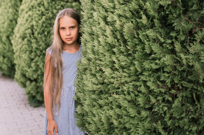 Portrait face of candid offended upset little kid girl of eight years old with long blond hair