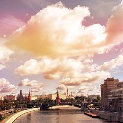 View of cityscape against cloudy sky