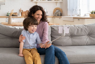 Smiling mother and son talking on video call