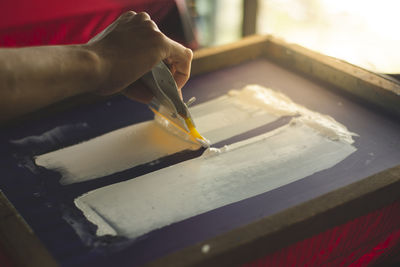 Cropped hand of person working in workshop